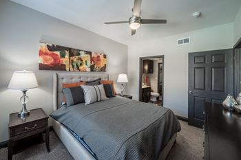 a bedroom with a bed and a ceiling fan
